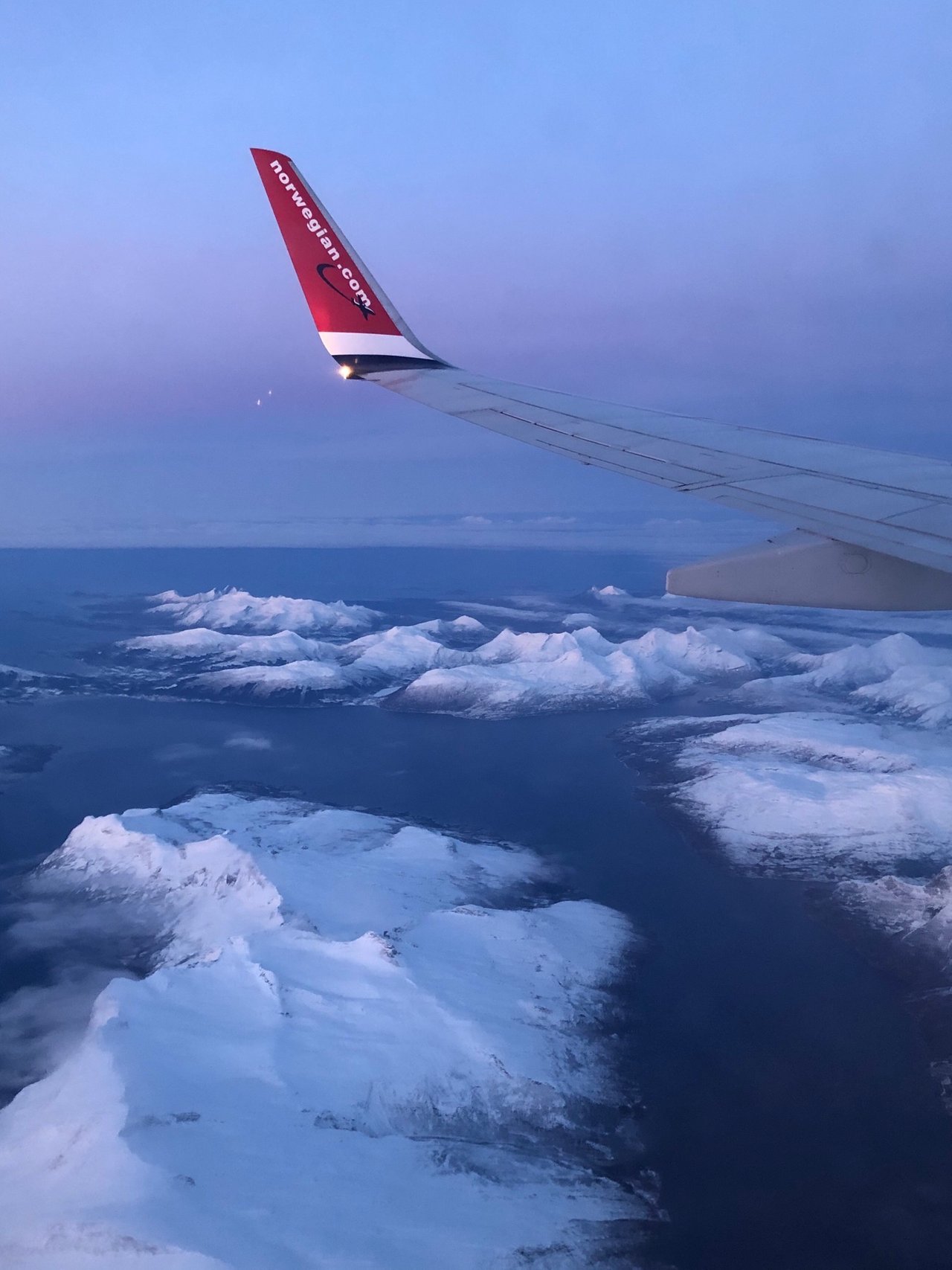 View from plane window travel to Northern Norway PeakD