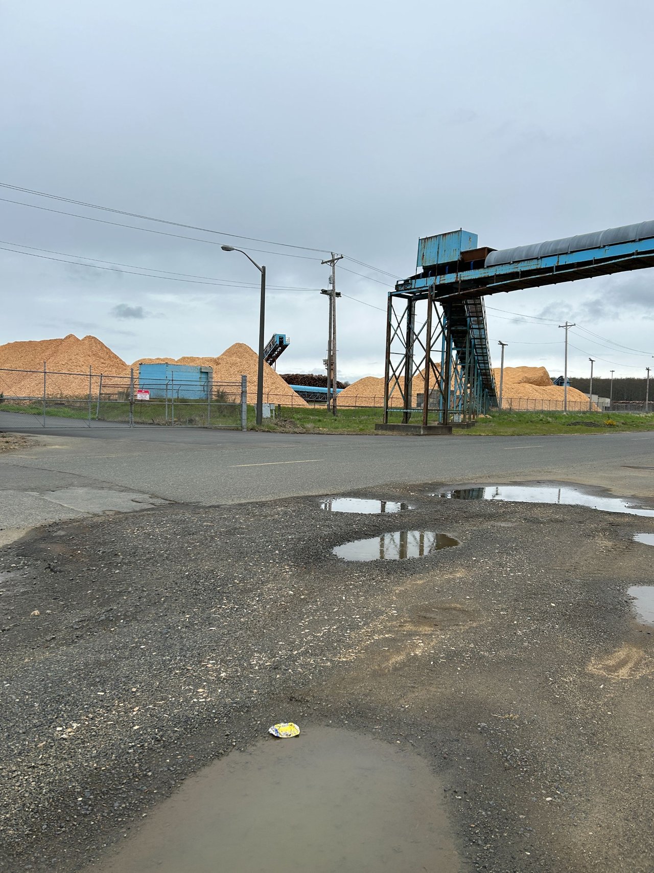 Conveyer belt goes across street to pier