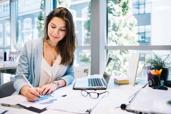 https://img.freepik.com/premium-photo/cheerful-woman-writing-documents_23-2147669364.jpg?w=600