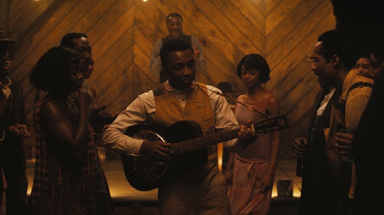 https://www.slashfilm.com/img/gallery/sinners-review-ryan-cooglers-bloody-vampire-masterclass-is-2025s-movie-to-beat/sinners-is-an-ode-to-music-and-a-cautionary-tale-about-the-monsters-among-us-1744292045.jpg