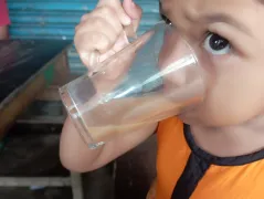 An amazing scene of my daughter eating bread with milk and tea in the morning