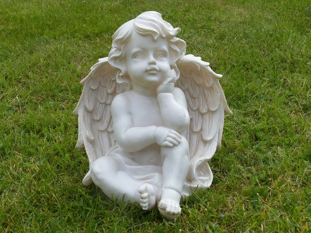 Angel sitting on the grass