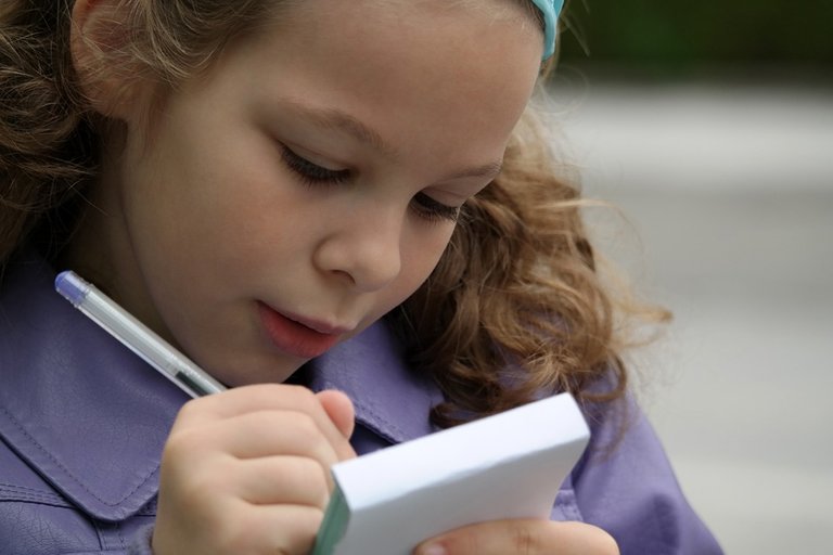 Young girl taking observational notes