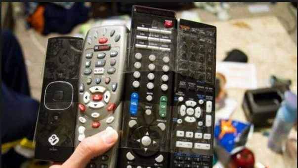 Funny image of an "Universal Remote, with several remotes taped together"