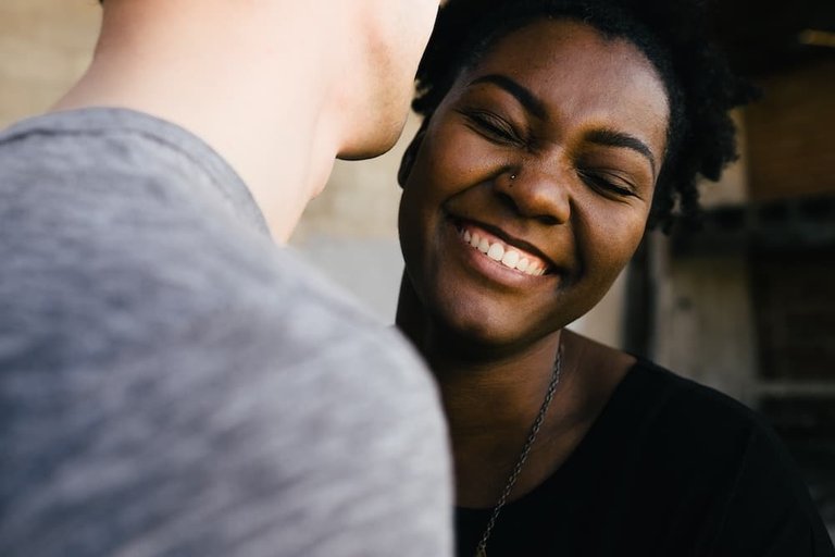 Young man telling another woman a secret