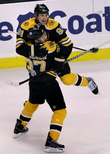 Marc Savard celebrates a goal with teammate Patrice Bergeron