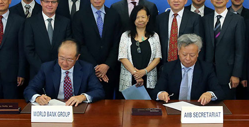 AIIB Secretariat Jin Liqun signs a cooperation pact with the World Bank - from China Daily