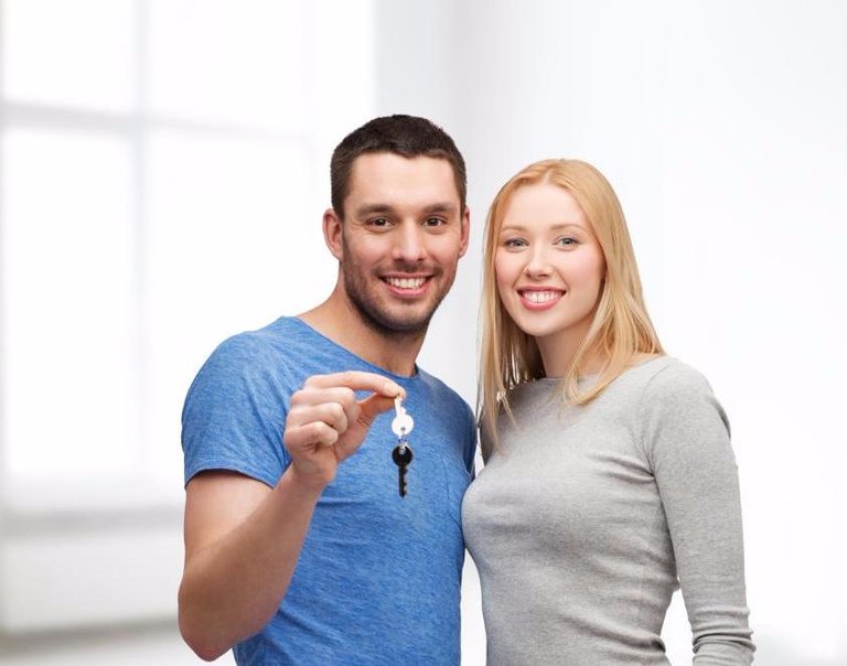 smiling couple holding keys