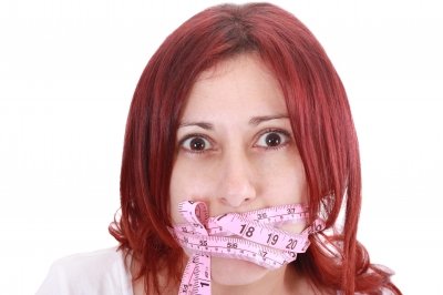 Woman gagged by a measuring tape