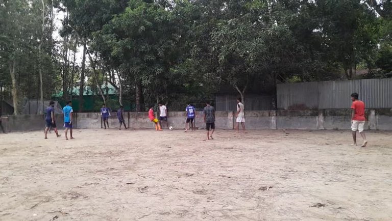 Playing football in the afternoon.