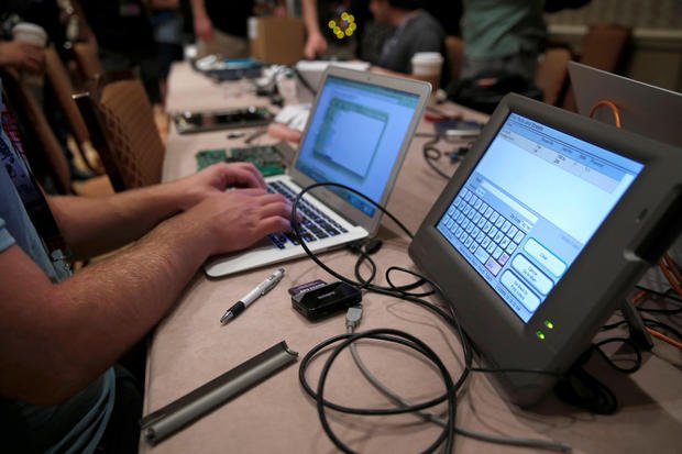 A hacker tries to access and alter data from an electronic poll book in a Voting Machine Hacking Village during the Defcon hacker convention in Las Vegas, Nevada, U.S. on July 29, 2017.  REUTERS