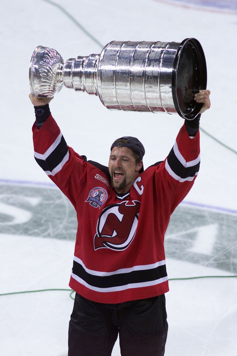 New Jersey Devils' team captain Scott Stevens hoisting the Stanley Cup in June 2000