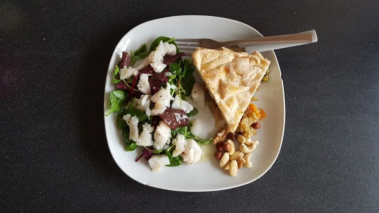 cldjas0nx004k79sz59pbhq1h_peashoot_salad_with_cod_homemade_curried_veg_pie_and_mixed_nuts.webp
