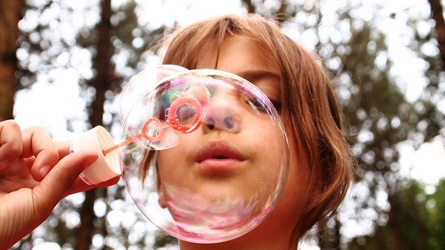 picture of a kid blowing bubbles
