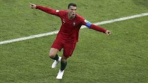 Cristiano-Ronaldo-celebrates-after-scoring-his-sides-2nd-goal-during-the-group-B-match-between-Portugal-and-Spain-at-the-2018-soccer-World-Cup-in-the-Fisht-Stadium-in-Sochi.jpg