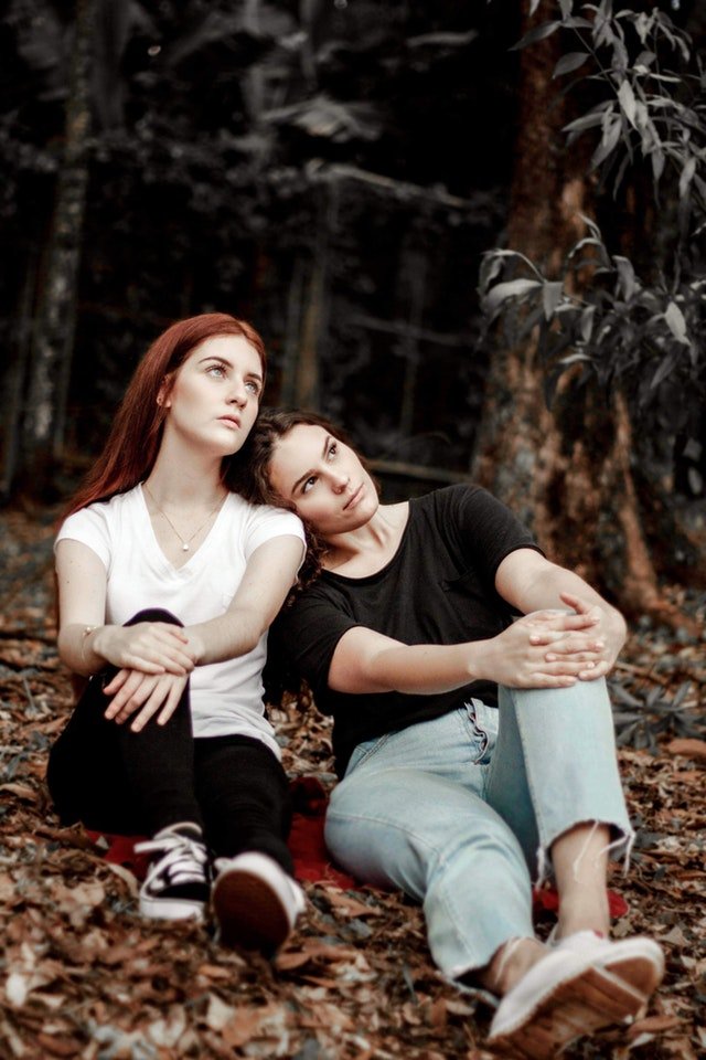 two-women-sitting-near-trees-2418886.jpg