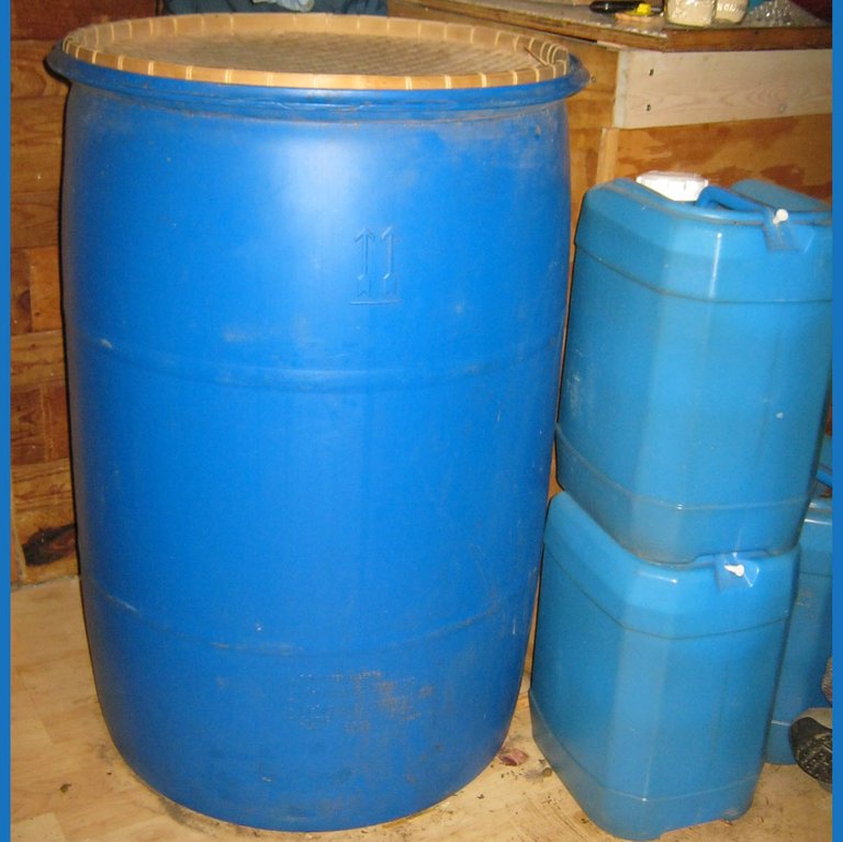 water barrel and jugs in porch.JPG