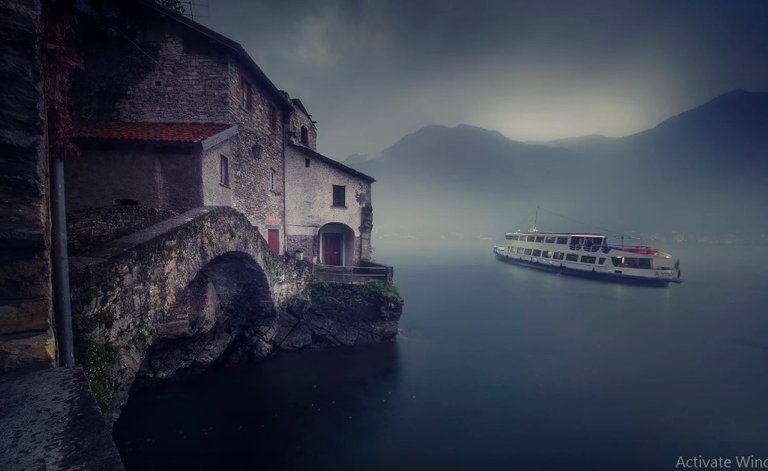 The ferry of Como Lake crossing by Nesso's old bridge.jpg
