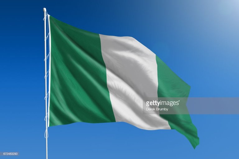 national-flag-of-nigeria-on-clear-blue-sky-picture-id672483290.jpeg