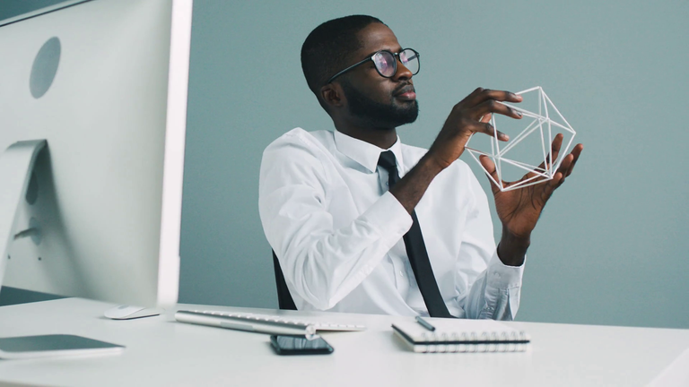 videoblocks-young-attractive-african-business-man-holding-the-decoration-in-the-hands-thinking-about-future-plans-at-the-work-in-the-office-background_rbwltgoew_thumbnail-full01.png
