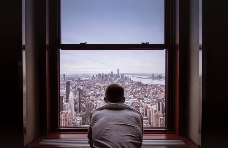 man-in-gray-shirt-looking-at-city-buildings-3625023.jpg