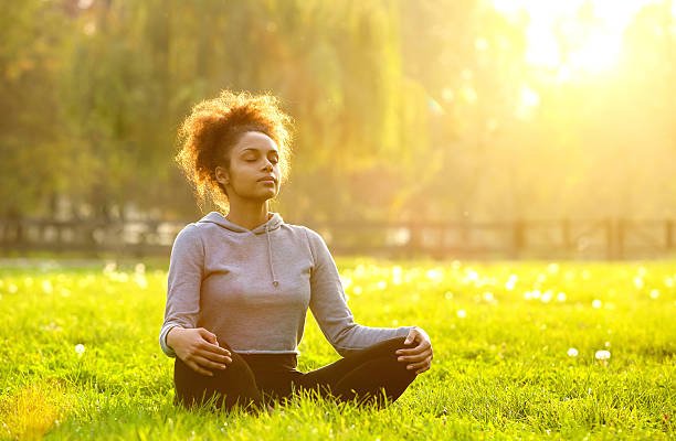 african-american-woman-meditating-in-nature-picture-id478811176.jpg