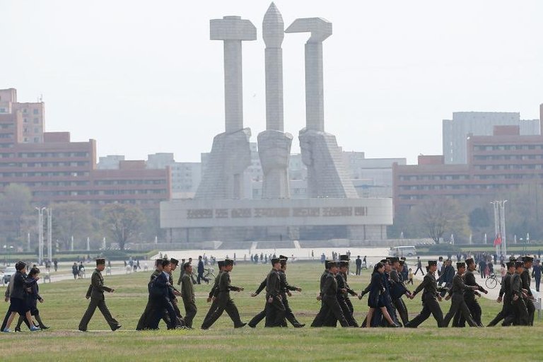 Soldiers walk in front of the Monument to the Foundation of the Workers' Party in Pyongyang April 16, 2017. REUTERS.Damir Sagolj.jpg