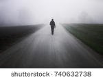 stock-photo-man-alone-on-foggy-road-740632738.jpg