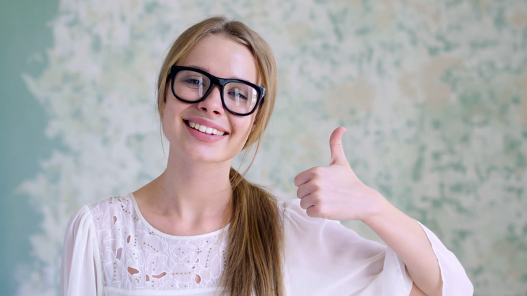 cute-girl-teenager-giving-thumbs-up-closeup-smile-of-pleasure-indoors-room-at-home-arm-holding-gesture-cool-lady-with-fresh-clean-skin-looking-at-camera-bright-natural-lighting-close-up-sweet-20s_rm48ogga_thumbn.png