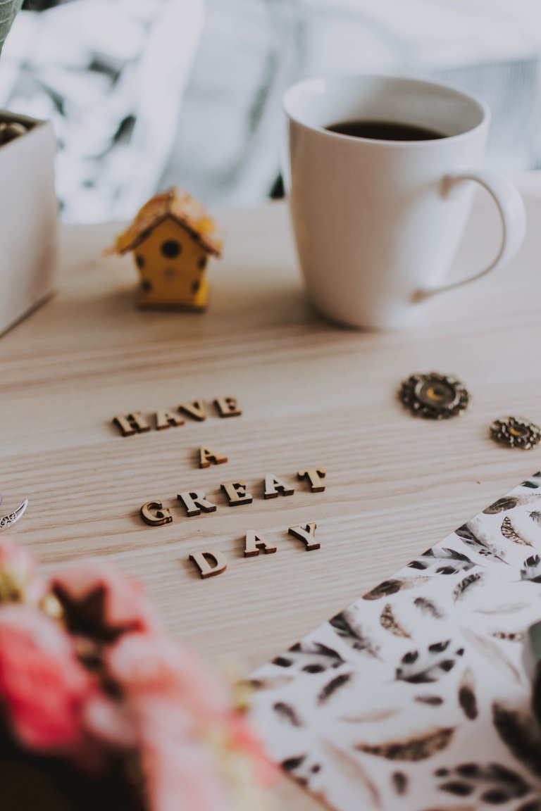 white-ceramic-mug-beside-brown-wooden-house-ornament-3709091.jpg