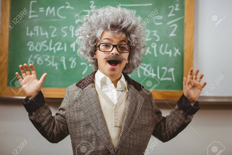 43914789-portrait-of-little-einstein-smiling-in-front-of-chalkboard-in-a-classroom.jpg