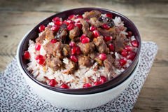 beef-stew-white-rice-pomegranate-seeds-rustic-wooden-table-65780538(1).jpg
