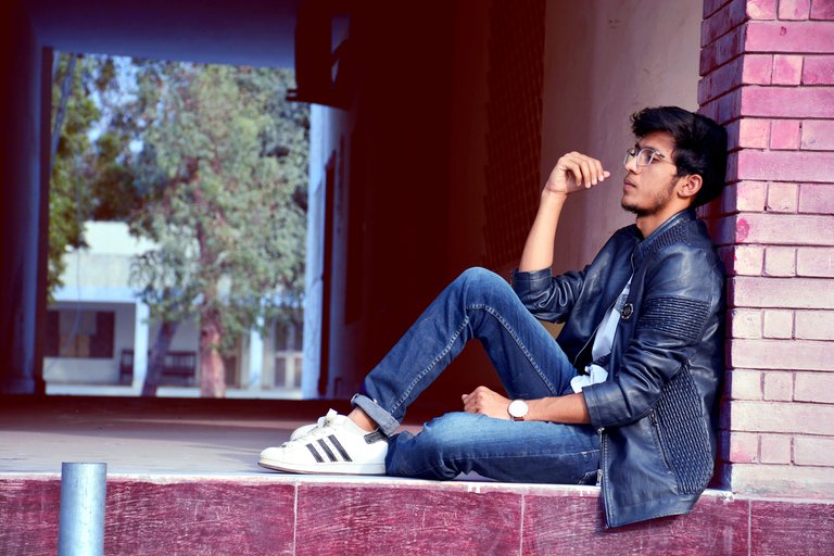 man-wearing-black-leather-jacket-and-blue-jeans-sitting-on-1050543.jpg