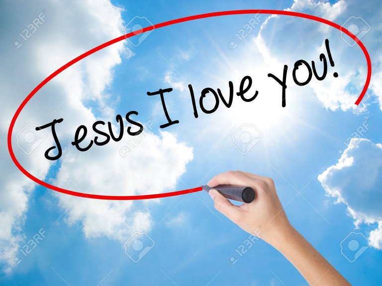 72217743-woman-hand-writing-jesus-i-love-you-with-black-marker-on-visual-screen-isolated-on-sunny-sky-busines.jpg