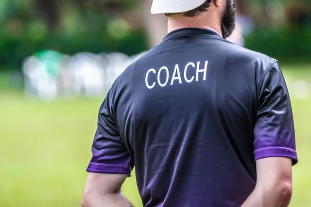 rear-view-of-coach-standing-on-field-royalty-free-image-1593182962.jpg