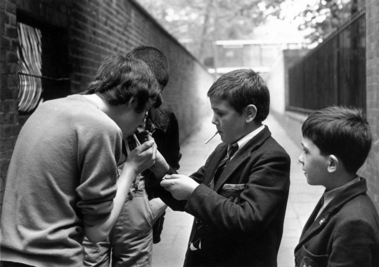 Holland Park Schoolboys lighting up illicit cigarettes 1970, Evening Standard/Getty Images)