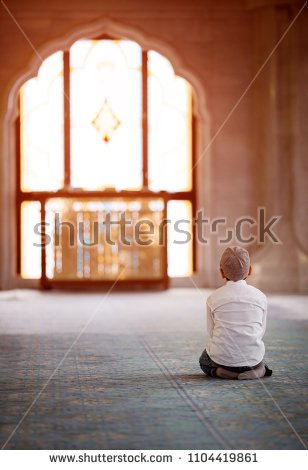 stock-photo-little-boy-praying-in-the-mosque-1104419861.jpg