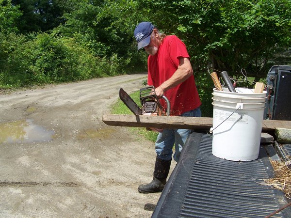 Fixing fence - David cutting post crop June 2018.jpg