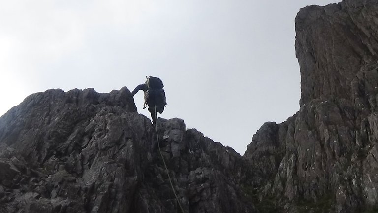 62 Kieran hopping over the top of a rocky section with the rope, readying it for us.jpg