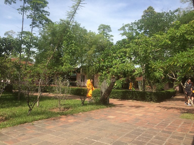 Saffron robed monks strolling through the gardens.jpg