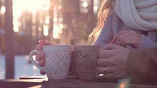 close-up-of-hands-of-loving-couple-with-hot-drink-on-valentines-day-on-sunset_bikfi3dde_thumbnail-full01.png