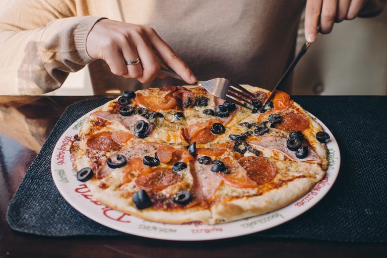 Canva - Person Eating Pizza.jpg