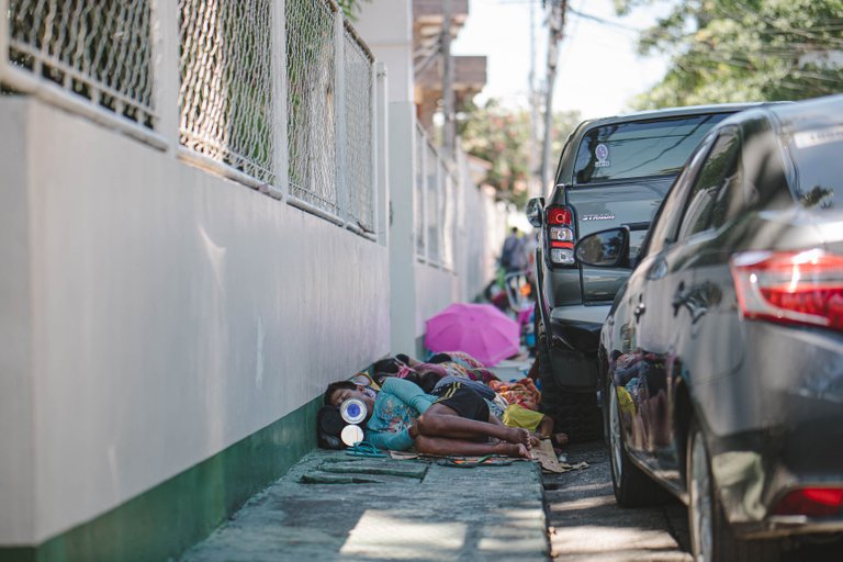 people-lying-on-pavement-beside-parked-vehicles-3453011.jpg