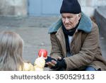 stock-photo-getting-food-kind-little-girl-gives-apple-to-a-homeless-person-350529113.jpg