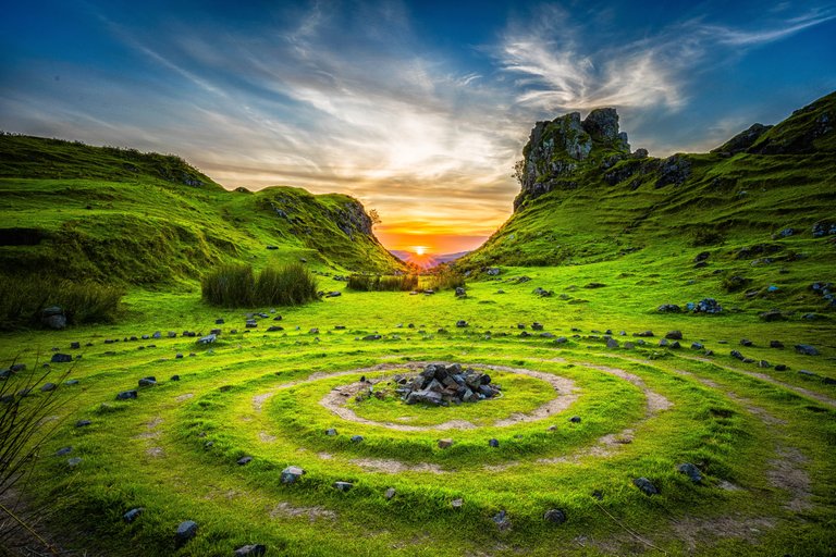 Sunset on green grassy hills of some ancient meeting place