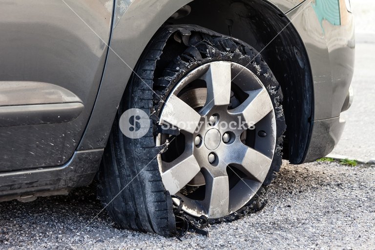 storyblocks-destroyed-blown-out-tire-with-exploded-shredded-and-damaged-rubber-on-a-modern-suv-automobile-flat-low-profile-tyre-on-an-alloy-rim-ripped-open-in-pieces-with-visible-interior_BvsSG0X9f_SB_PM.jpg
