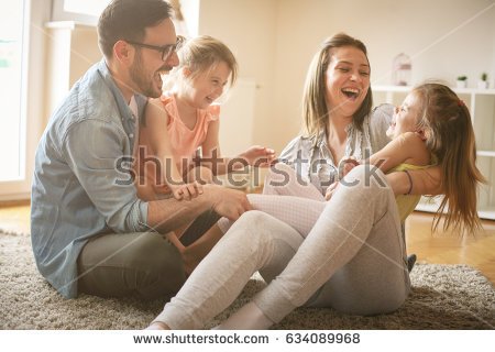 stock-photo-happy-family-with-two-daughters-playing-at-home-family-sitting-on-floor-and-playing-together-634089968.jpg