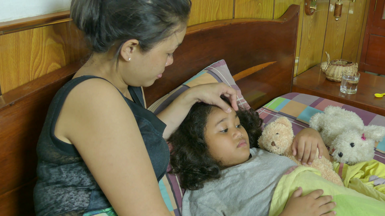 videoblocks-high-angle-medium-view-of-asian-mother-with-sick-daughter-she-takes-her-temperature-with-a-thermometer-and-reacts-one-of-a-series-of-multicultural-lifestyle-and-people-clips_r-quq5fz_thumbnail-full01.png