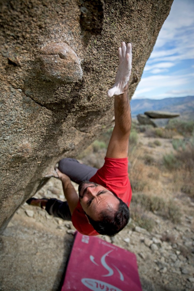 man-climbing-on-gray-concrete-peak-at-daytime-946337.jpg