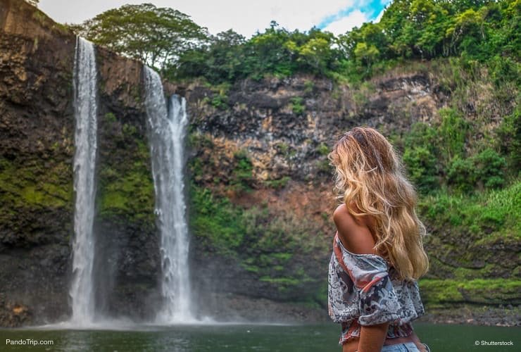 Beautiful-woman-looking-at-Wailua-Falls-Kauai-Hawaii.jpg